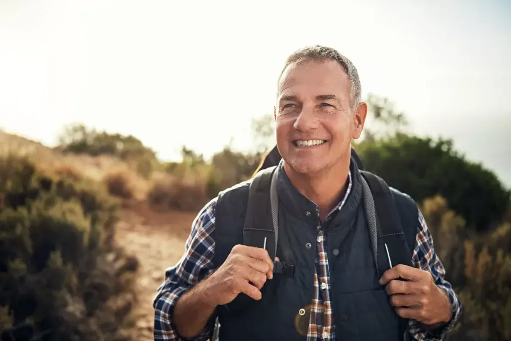 a man hiking in nature feeling better after taking hormone replacement therapy for men